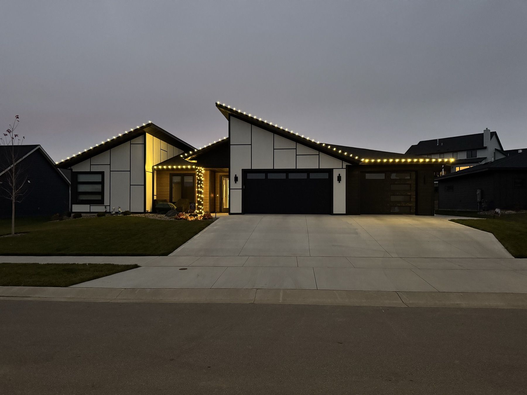 Modern home with roofline lights along every peak